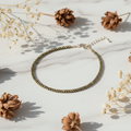 Pyrite Crystal Anklet on white marble with dried flowers