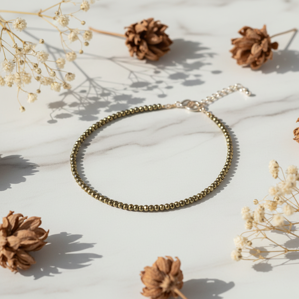Pyrite Crystal Anklet on white marble with dried flowers
